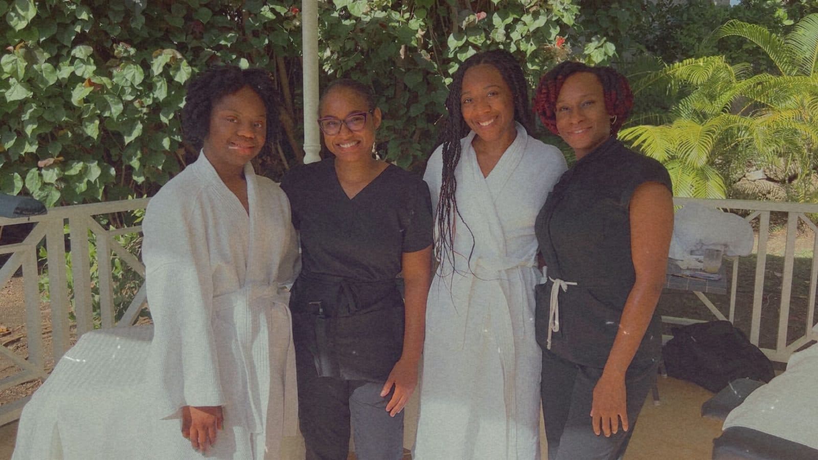 Two TUTCH therapists with two guests in spa robes enjoying a spa day in Barbados