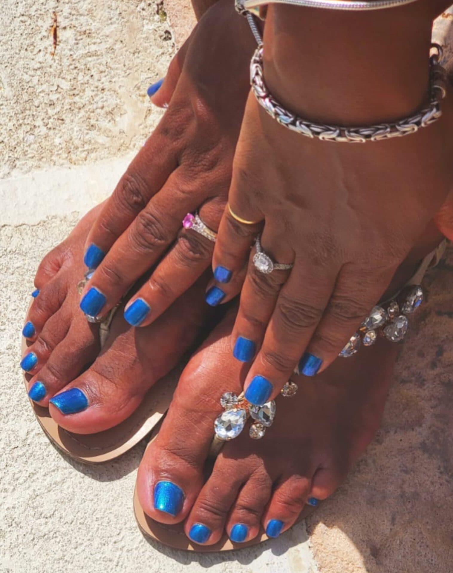 Matching blue gel manicure and pedicure with jeweled sandals, done at home in Barbados
