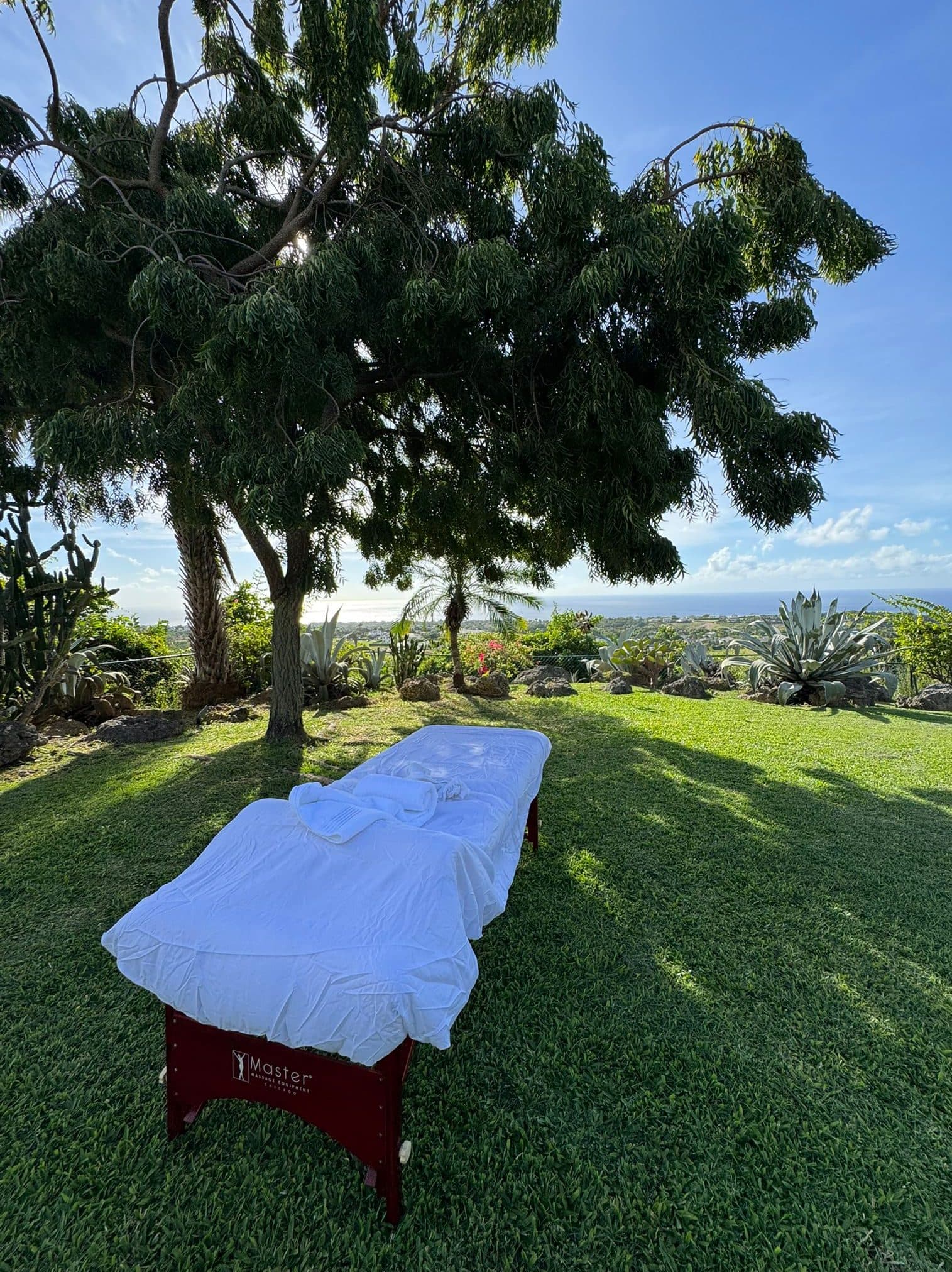 Massage table set up on a hillside lawn for an outdoor massage in Barbados