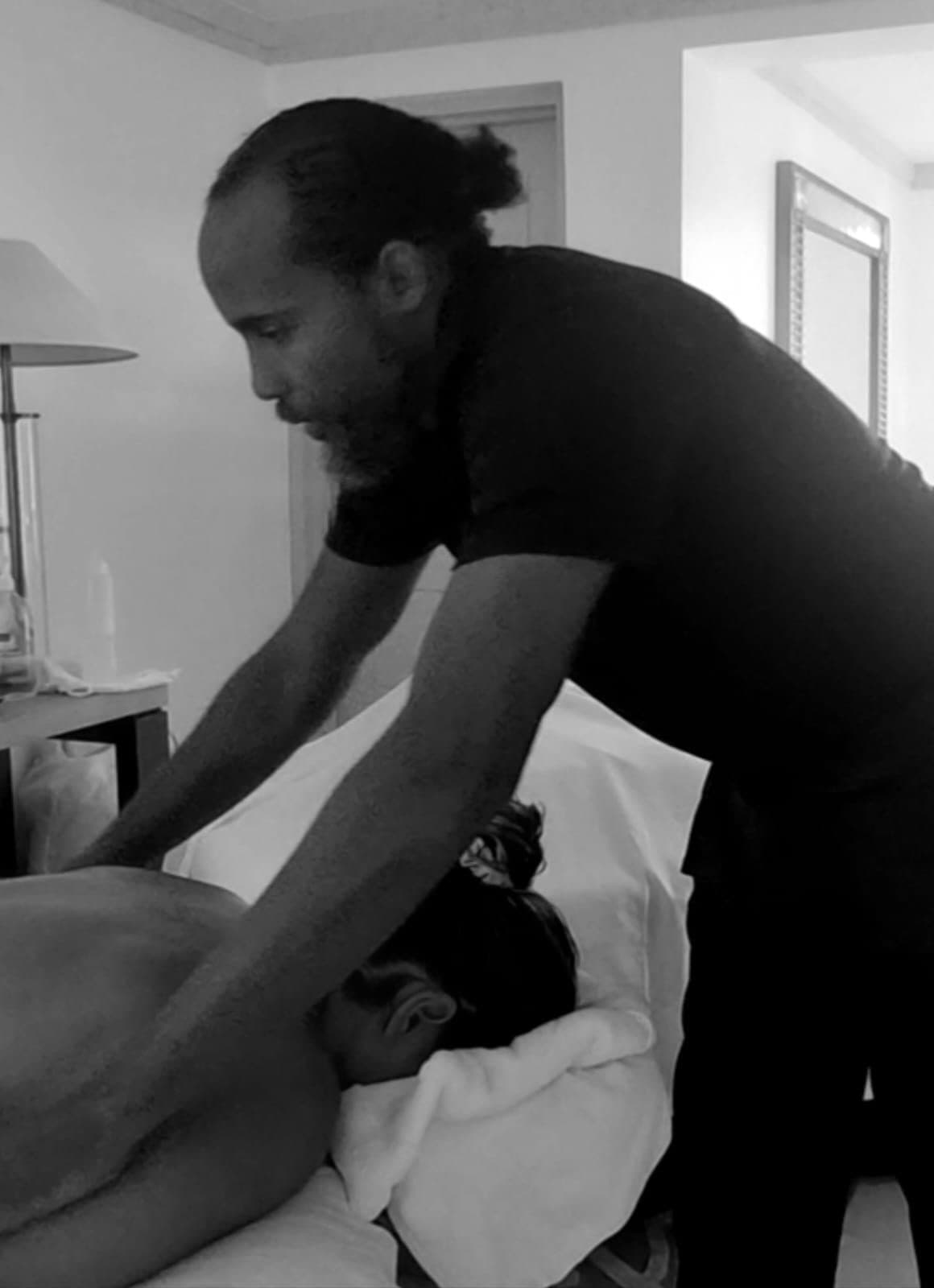 Black and white photo of a TUTCH therapist giving a therapeutic massage