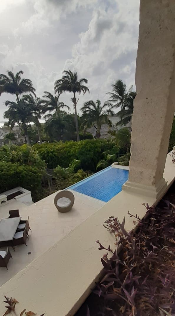 Villa terrace overlooking a pool where a mobile massage can be set up in Barbados